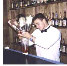 Bartender pouring many bottles